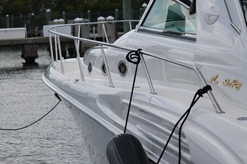 Knot Ez II Yacht Photos Pics 1998 Sea Ray 450 Sundancer yacht docked at marina, side view.