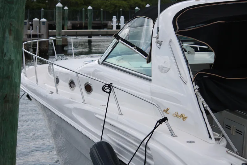 Knot Ez II Yacht Photos Pics 1998 Sea Ray 450 Sundancer yacht docked at marina, featuring sleek white design.