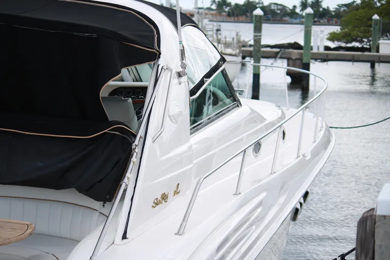 Knot Ez II Yacht Photos Pics 1998 Sea Ray 450 Sundancer yacht docked at marina, featuring sleek white design.