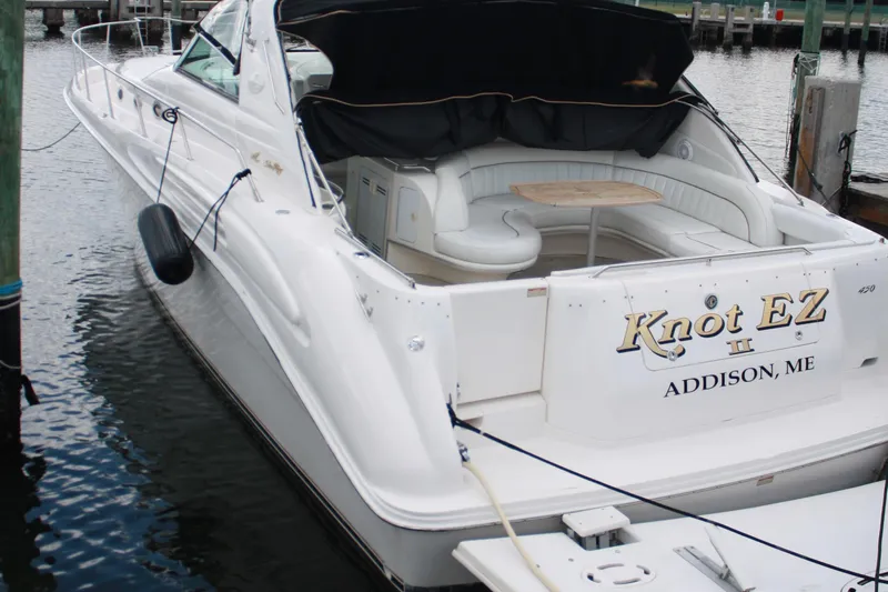 Knot Ez II Yacht Photos Pics 1998 Sea Ray 450 Sundancer yacht docked, featuring spacious seating and elegant design.