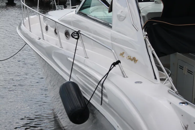 Knot Ez II Yacht Photos Pics 1998 Sea Ray 450 Sundancer yacht docked with fender, sleek white design.