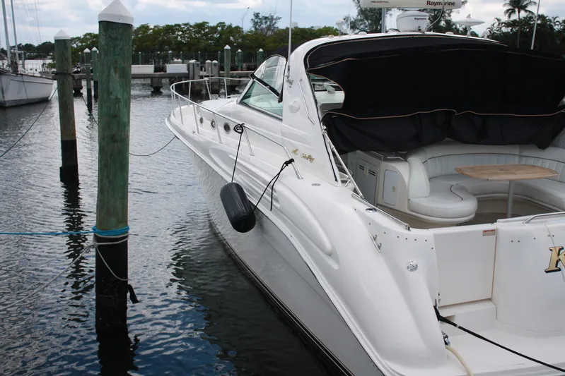 Knot Ez II Yacht Photos Pics 1998 Sea Ray 450 Sundancer yacht docked at marina, featuring sleek design and spacious seating.