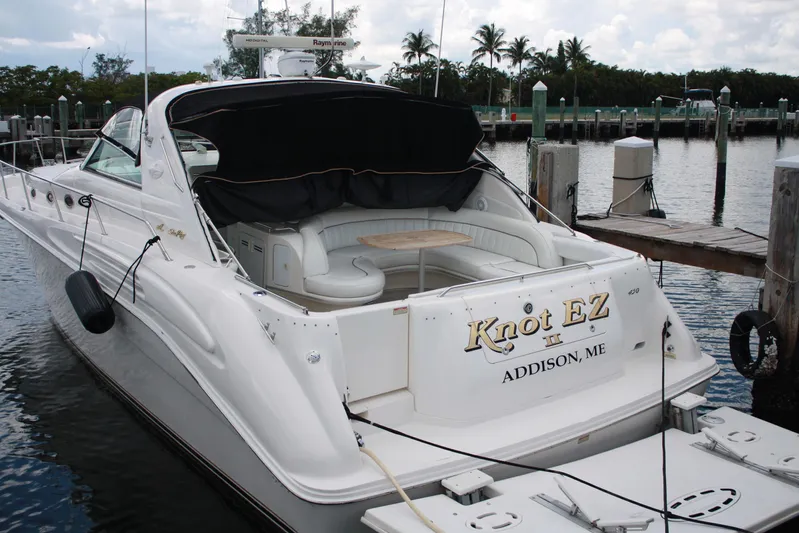 Knot Ez II Yacht Photos Pics 1998 Sea Ray 450 Sundancer yacht docked, featuring spacious seating and elegant design.