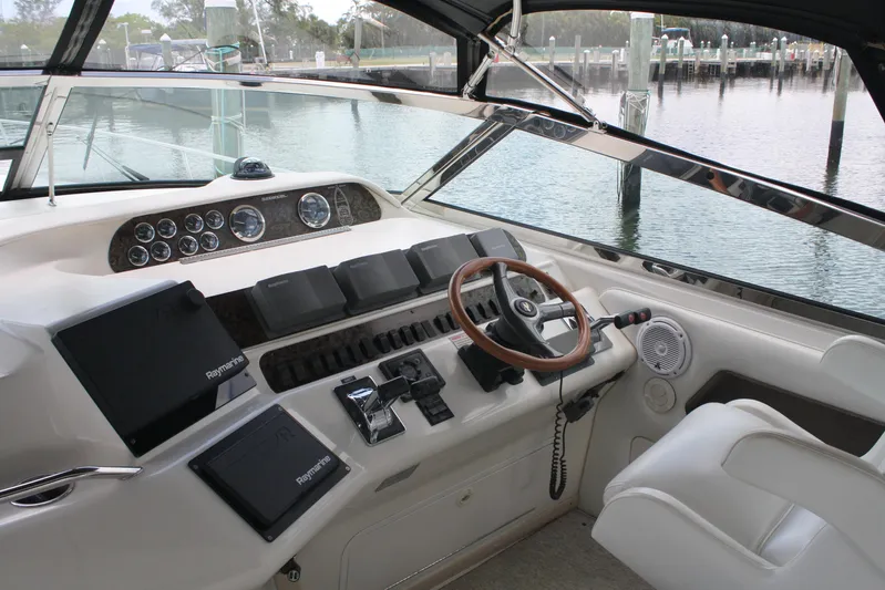 Knot Ez II Yacht Photos Pics 1998 Sea Ray 450 Sundancer helm with modern navigation equipment and luxurious seating.