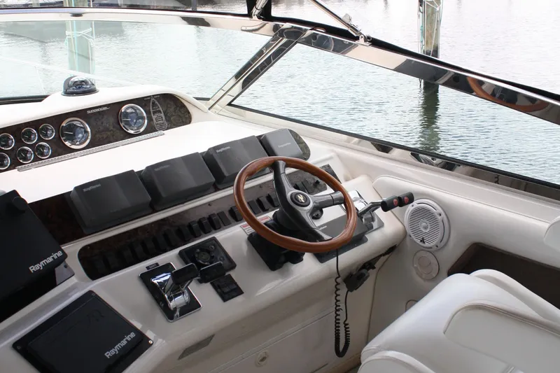 Knot Ez II Yacht Photos Pics 1998 Sea Ray 450 Sundancer helm with wood steering wheel and Raymarine electronics.