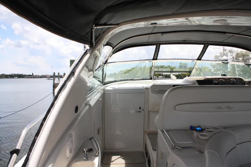 Knot Ez II Yacht Photos Pics 1998 Sea Ray 450 Sundancer yacht interior with helm and seating, docked by the water.