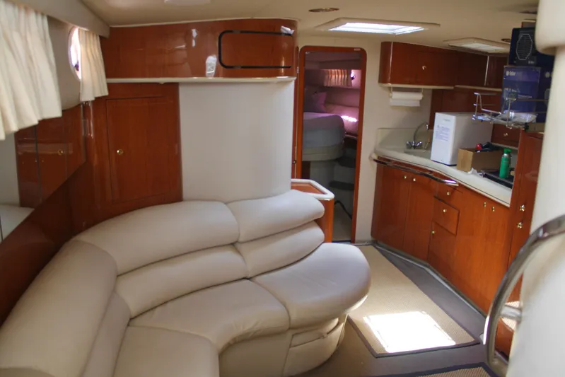 Knot Ez II Yacht Photos Pics Interior of 1998 Sea Ray 450 Sundancer yacht with leather seating and wooden cabinetry.