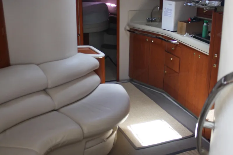 Knot Ez II Yacht Photos Pics Interior of 1998 Sea Ray 450 Sundancer yacht with leather seating and compact kitchenette.