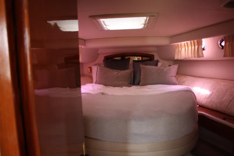 Knot Ez II Yacht Photos Pics Luxurious cabin interior of 1998 Sea Ray 450 Sundancer yacht with cozy bedding.