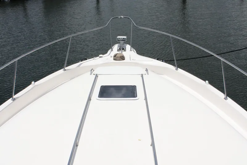 Knot Ez II Yacht Photos Pics Bow view of 1998 Sea Ray 450 Sundancer yacht on calm water.