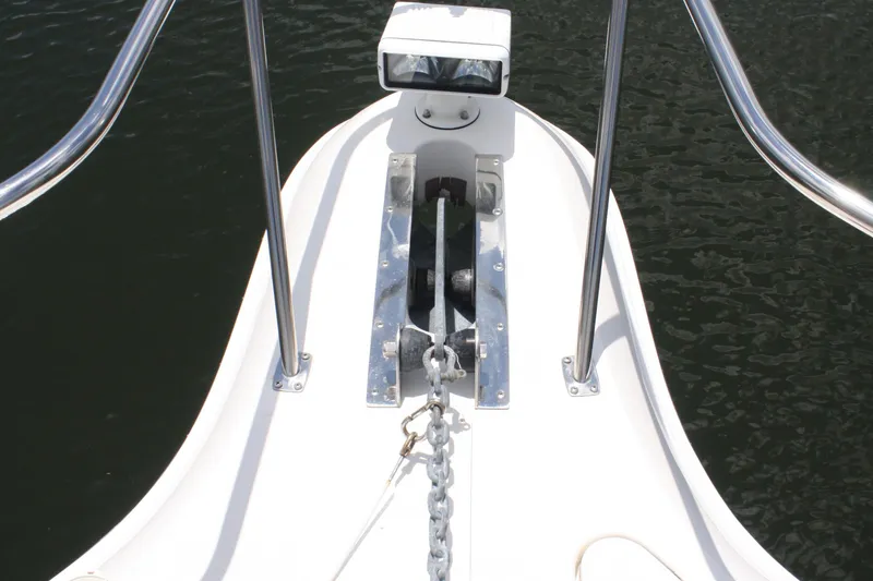 Knot Ez II Yacht Photos Pics Bow of 1998 Sea Ray 450 Sundancer with anchor and railing over water.