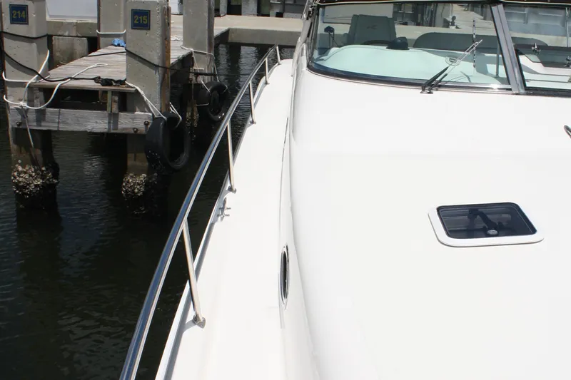 Knot Ez II Yacht Photos Pics 1998 Sea Ray 450 Sundancer yacht docked at marina, showcasing sleek design and deck details.