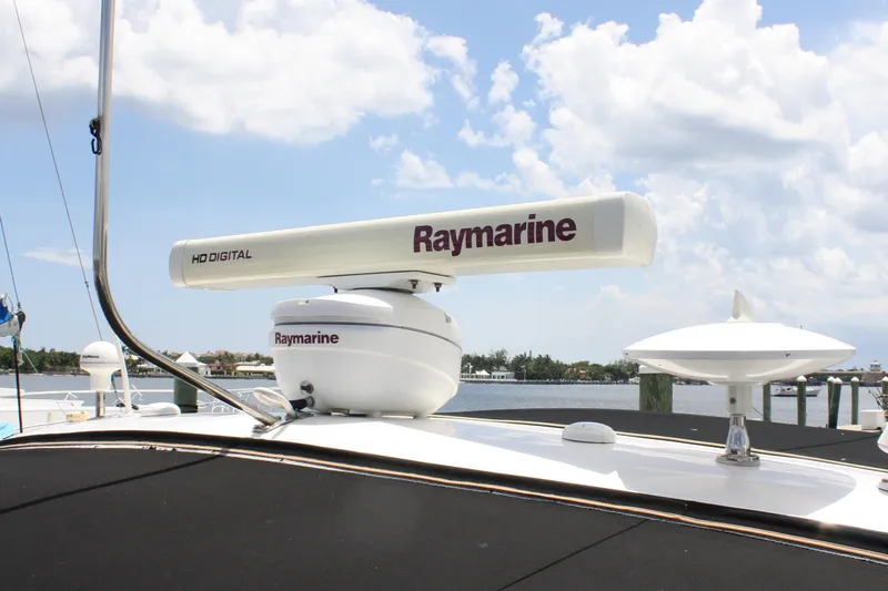 Knot Ez II Yacht Photos Pics Radar equipment on 1998 Sea Ray 450 Sundancer yacht under a cloudy sky.