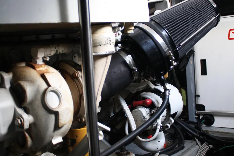 Knot Ez II Yacht Photos Pics Engine compartment of a 1998 Sea Ray 450 Sundancer boat, showcasing mechanical components.