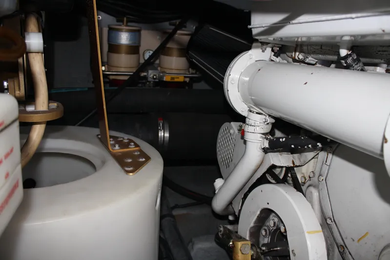 Knot Ez II Yacht Photos Pics Engine room of a 1998 Sea Ray 450 Sundancer, showcasing mechanical components and piping.