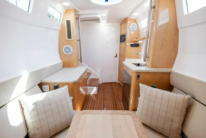 Yacht Photos Pics Interior of 2015 Intrepid 475 Panacea boat with wood accents and seating area.