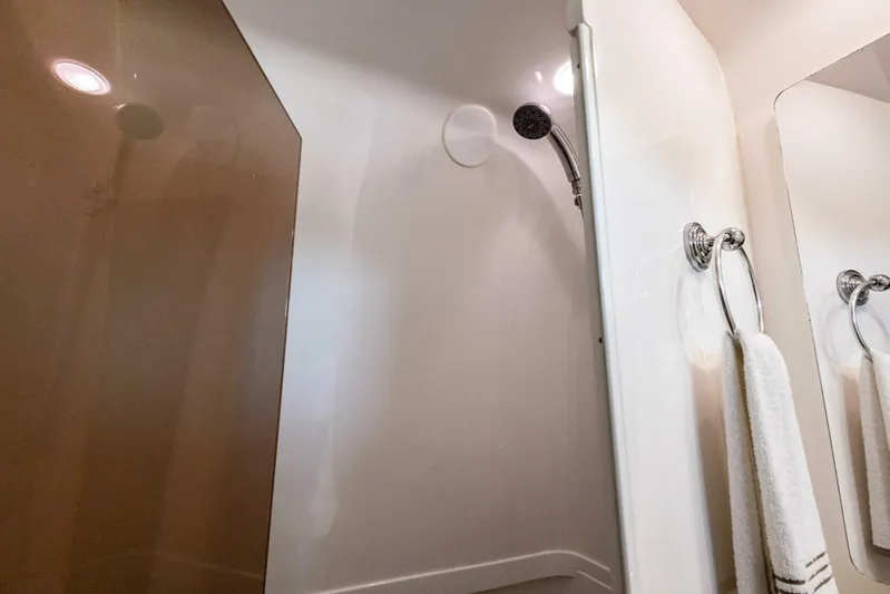  Yacht Photos Pics Shower area in 2015 Intrepid 475 Panacea boat, featuring modern fixtures and towel rack.