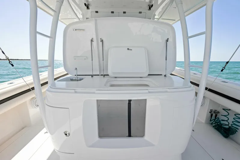  Yacht Photos Pics 2015 Intrepid 475 Panacea boat interior with sleek white design and ocean backdrop.