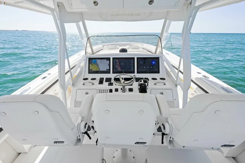  Yacht Photos Pics 2015 Intrepid 475 Panacea boat cockpit with advanced navigation systems on open sea.
