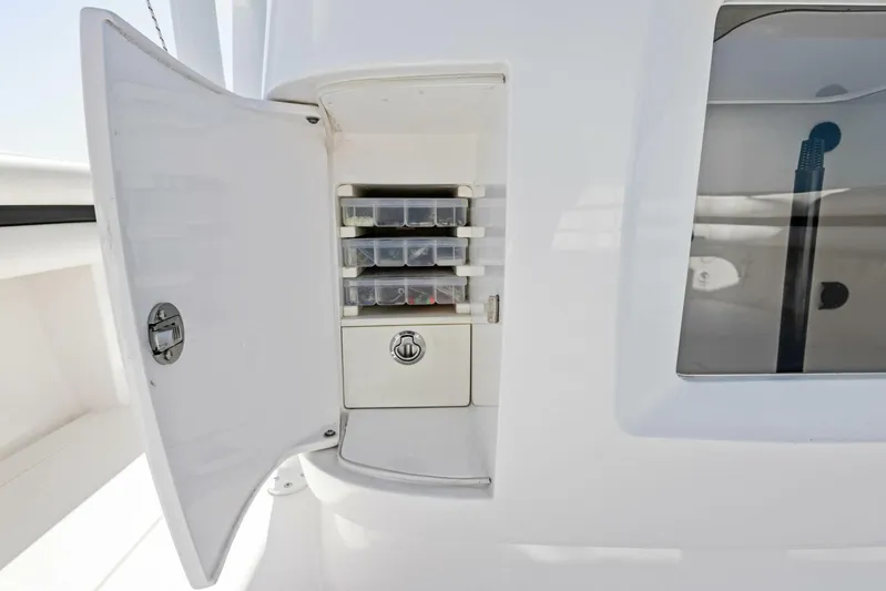  Yacht Photos Pics Open storage compartment on 2015 Intrepid 475 Panacea boat, featuring organized containers.