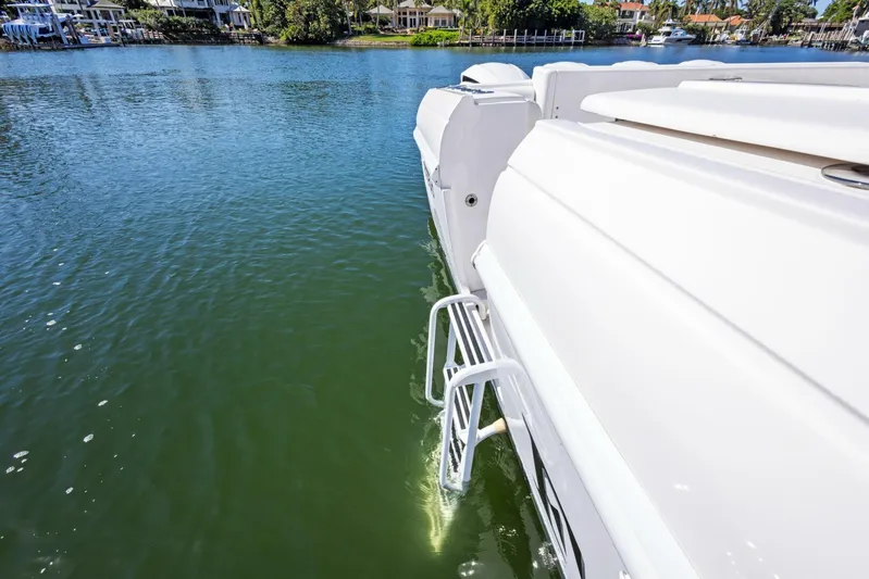  Yacht Photos Pics 2015 Intrepid 475 Panacea boat with swim ladder on calm water.