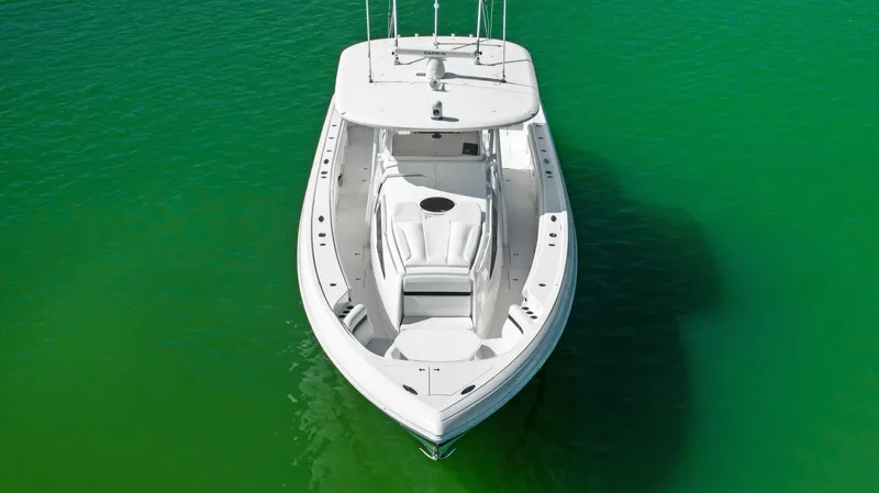 Yacht Photos Pics 2015 Intrepid 475 Panacea boat on vibrant green water, aerial view.
