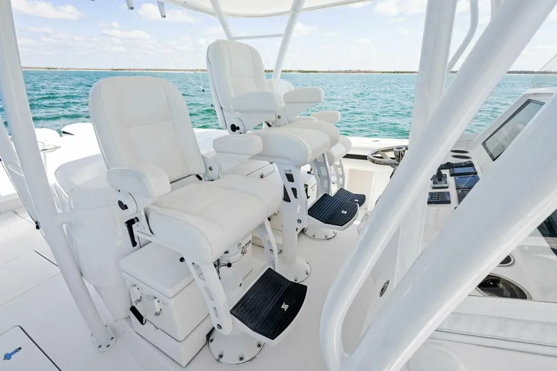  Yacht Photos Pics 2015 Intrepid 475 Panacea helm with white captain chairs and ocean view.