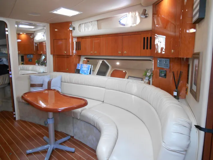 Cygnus Yacht Photos Pics Luxurious interior of 2000 Sea Ray Sundancer 410 yacht with leather seating and wooden cabinetry.
