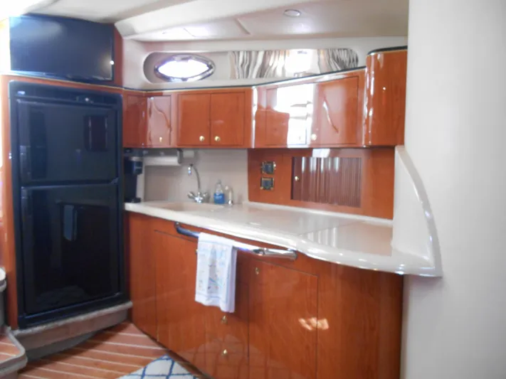 Cygnus Yacht Photos Pics Interior of 2000 Sea Ray Sundancer 410 yacht kitchen with wood cabinets and modern appliances.