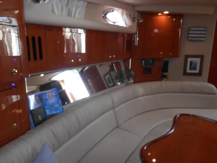 Cygnus Yacht Photos Pics Luxurious interior of 2000 Sea Ray Sundancer 410 yacht with plush seating and wood finishes.