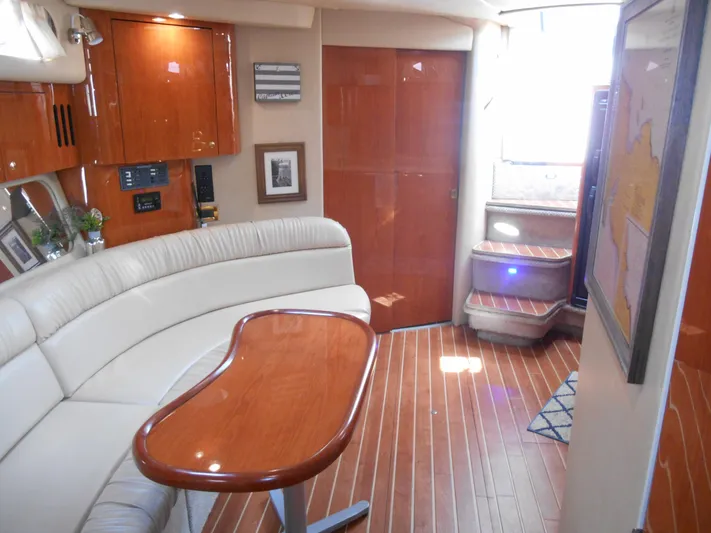 Cygnus Yacht Photos Pics Interior of 2000 Sea Ray Sundancer 410 yacht with elegant wood finishes and curved seating.
