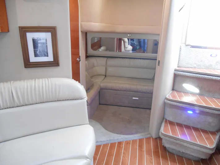 Cygnus Yacht Photos Pics Interior of 2000 Sea Ray Sundancer 410 yacht with plush seating and wooden flooring.