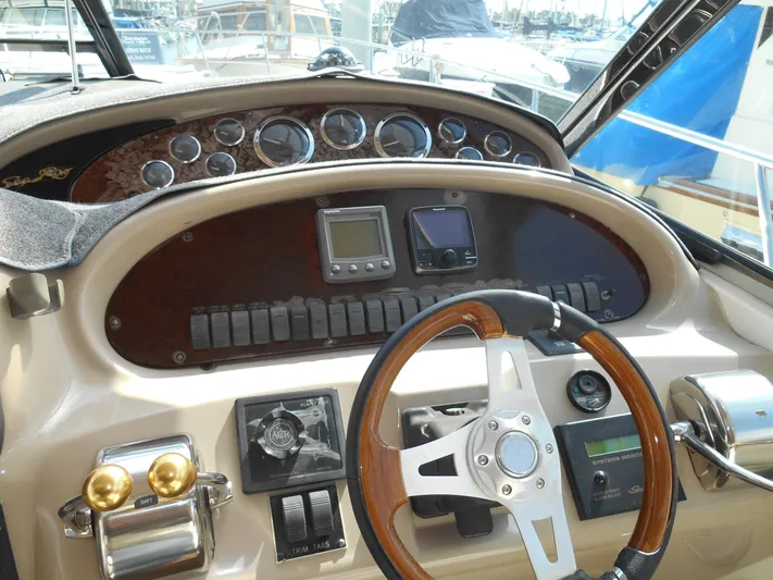 Cygnus Yacht Photos Pics Control panel of a 2000 Sea Ray Sundancer 410 yacht, featuring gauges and steering wheel.