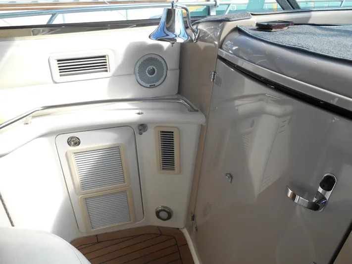 Cygnus Yacht Photos Pics Interior view of a 2000 Sea Ray Sundancer 410 yacht, featuring control panels and wood flooring.