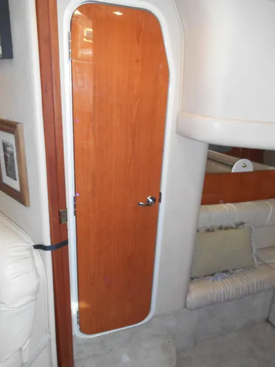 Cygnus Yacht Photos Pics Interior of 2000 Sea Ray Sundancer 410 yacht, featuring a wooden cabin door.