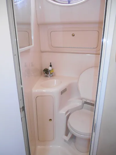 Cygnus Yacht Photos Pics Compact bathroom in 2000 Sea Ray Sundancer 410 yacht, featuring toilet and sink.