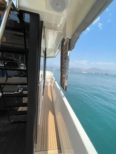  Yacht Photos Pics 2024 Beneteau Swift Trawler 41 Fly, side deck view, overlooking serene ocean waters.