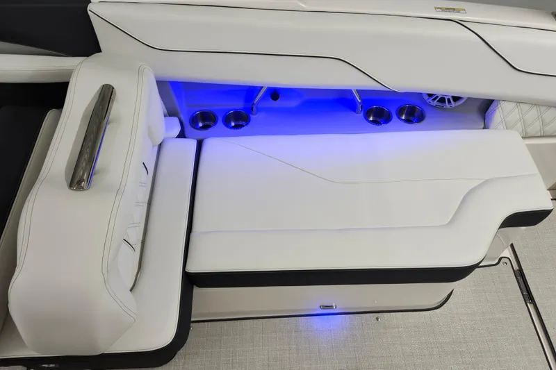  Yacht Photos Pics 2025 Regal LX4 boat interior with white seating, blue LED lighting, and cup holders.