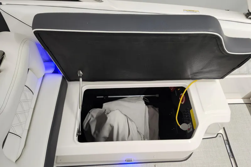  Yacht Photos Pics Open storage compartment in 2025 Regal LX4 boat with interior lighting.