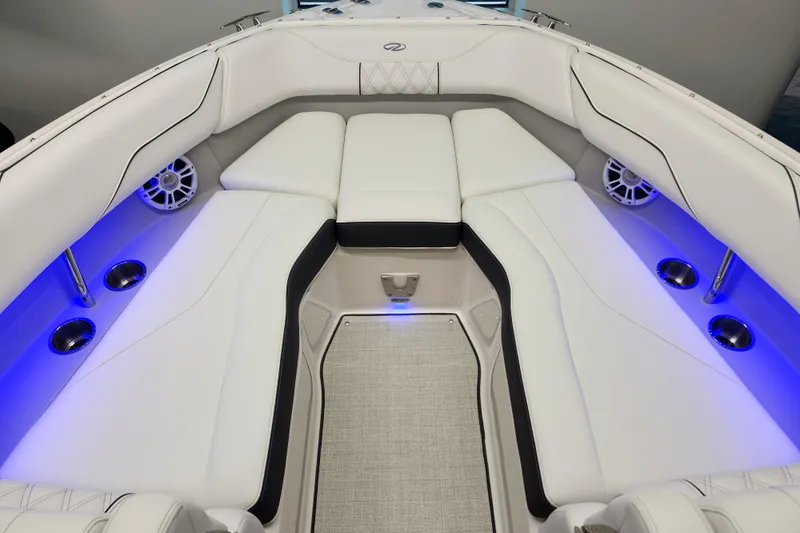  Yacht Photos Pics Luxurious interior of 2025 Regal LX4 boat with white seating and blue LED lighting.