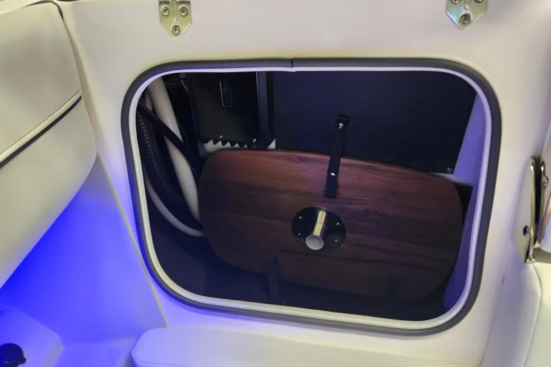  Yacht Photos Pics Storage compartment in 2025 Regal LX4 boat with blue LED lighting.