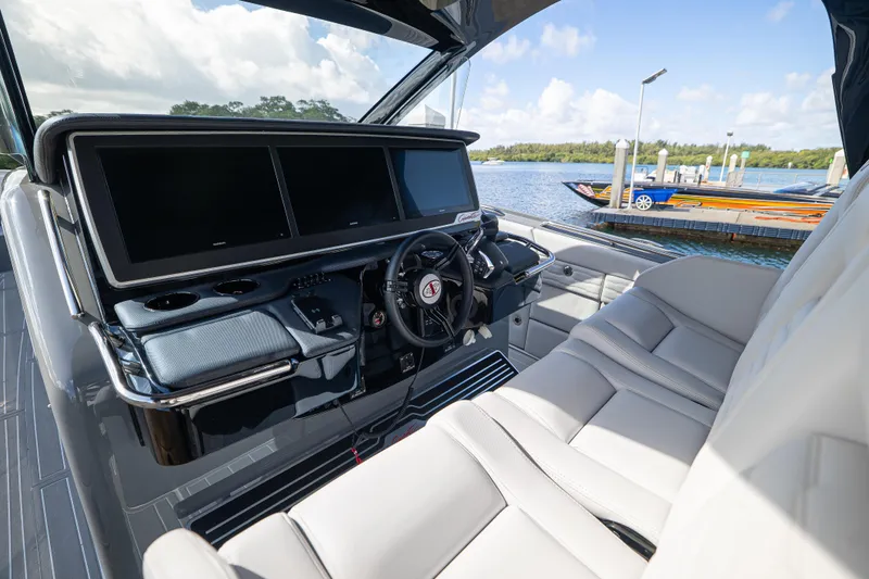  Yacht Photos Pics Luxurious 2026 Cigarette 42' Auroris boat interior with sleek dashboard and comfortable seating.