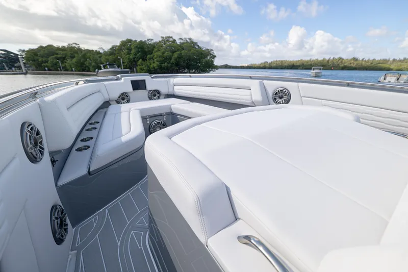  Yacht Photos Pics Luxurious 2026 Cigarette 42' Auroris boat interior with white seating and scenic water view.