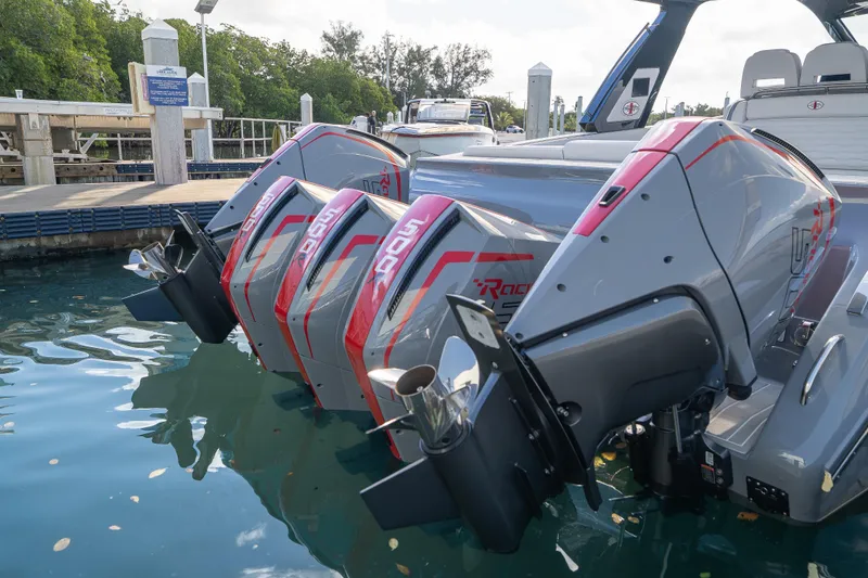  Yacht Photos Pics 2026 Cigarette 42' Auroris boat with triple outboard engines docked in marina.
