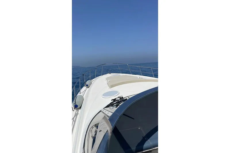  Yacht Photos Pics 2003 Cruisers Yachts 5470 Express on open sea under clear blue sky.