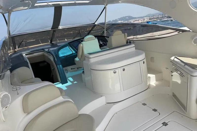  Yacht Photos Pics 2003 Cruisers Yachts 5470 Express interior with helm and seating area, ocean view.