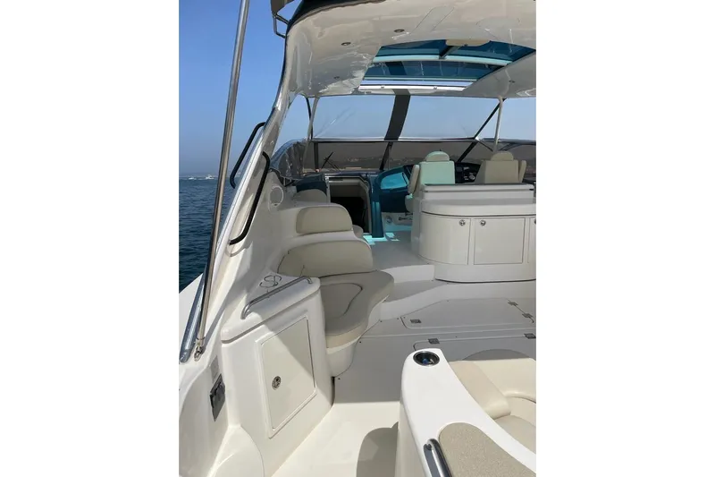  Yacht Photos Pics 2003 Cruisers Yachts 5470 Express interior with seating and helm, on open water.