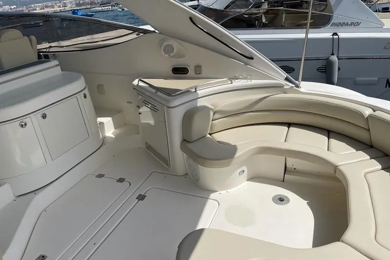  Yacht Photos Pics 2003 Cruisers Yachts 5470 Express interior with beige seating and storage compartments.