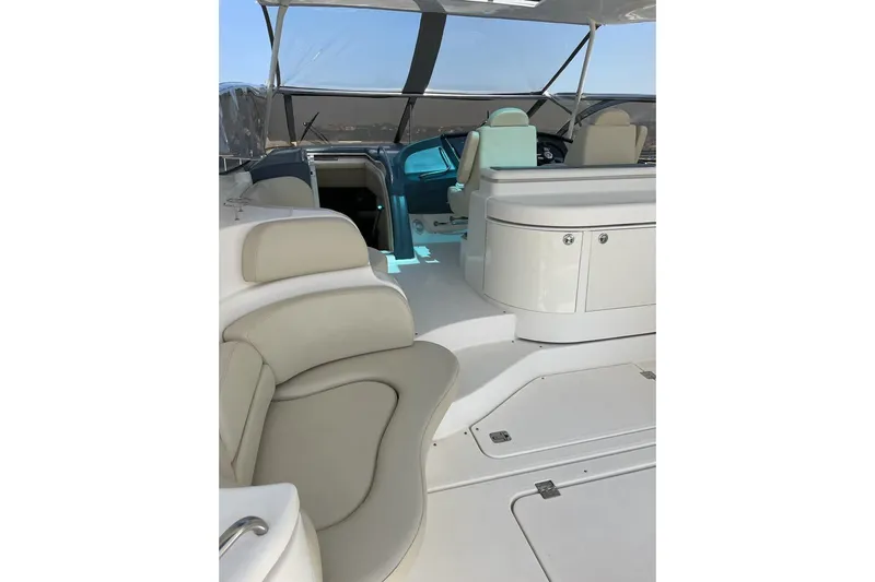  Yacht Photos Pics 2003 Cruisers Yachts 5470 Express interior with beige seating and helm station.