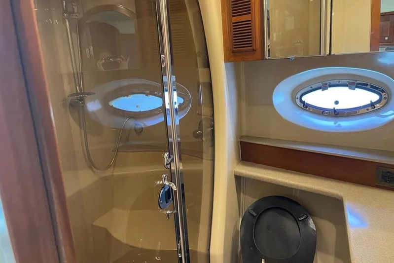  Yacht Photos Pics Luxurious bathroom in 2003 Cruisers Yachts 5470 Express with shower and porthole window.